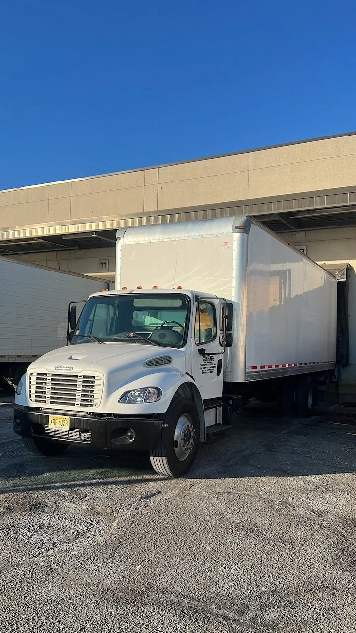 D&C Global Transportations 26-foot box truck at a loading facility